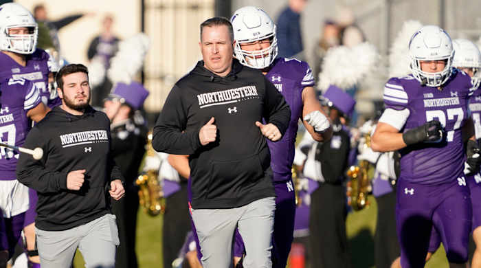 Pat Fitzgerald leading Northwestern onto the field.